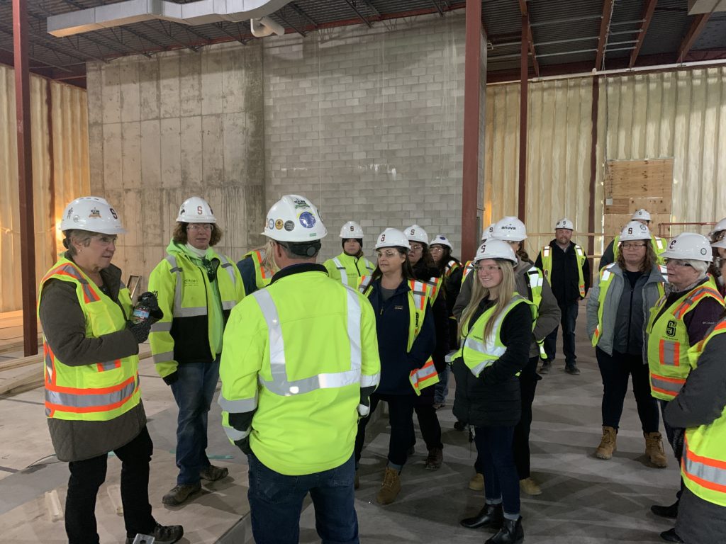 Group of construction workers conversing inside building