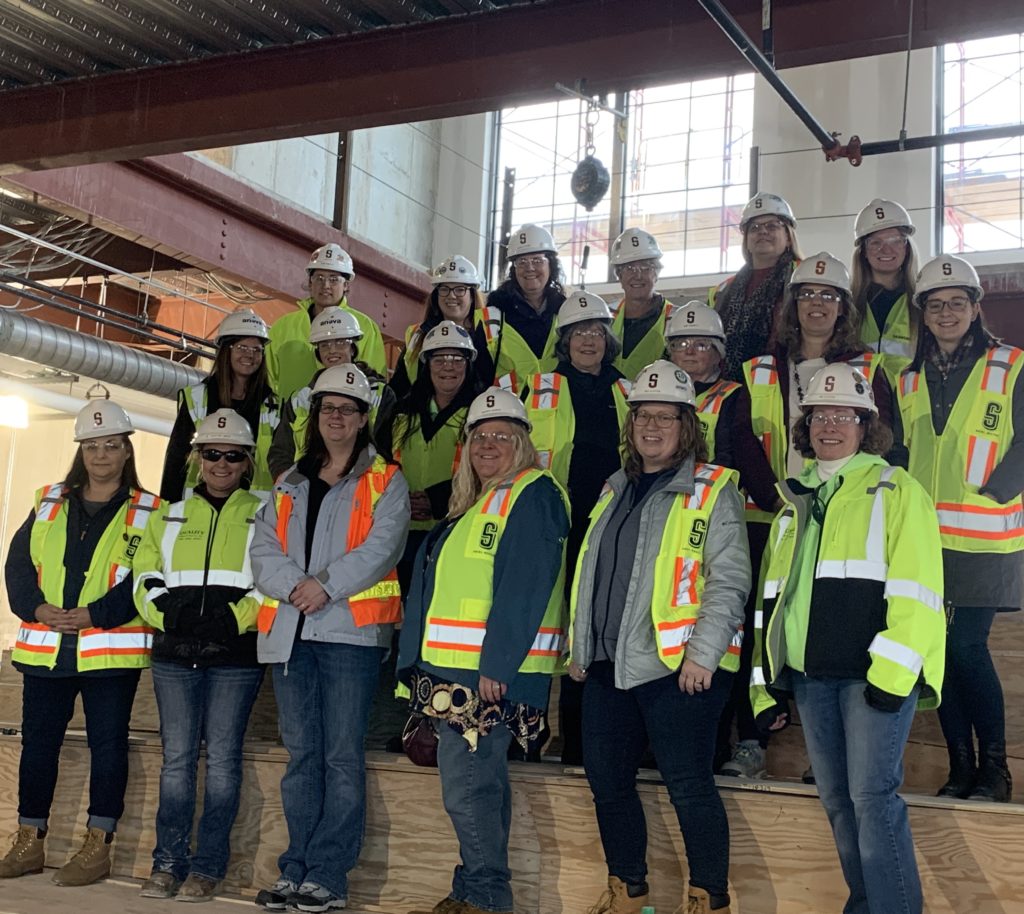 Group photo of women construction workers on platform